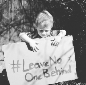 Junge mit #leavenoonebehind Plakat